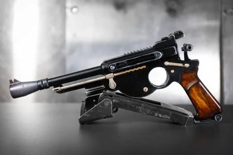 Pistol on a gray background Stock Photos