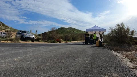 Pit Crews Busy Meeting Under The Tent While Racing Cars Passes By The Pit Stock Footage 125227190
