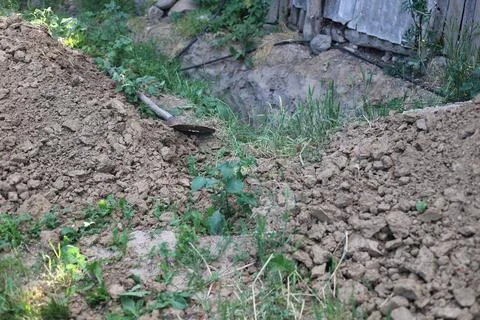 Pit dug for technical and electrical equipment Stock Photos