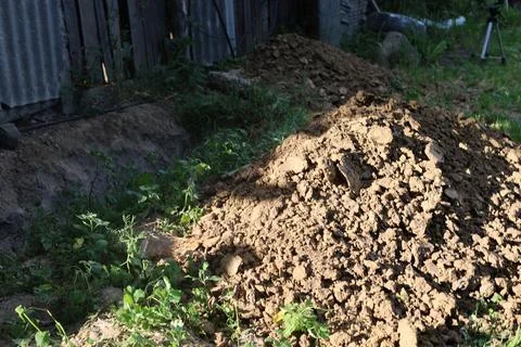 Pit dug for technical and electrical equipment Stock Photos