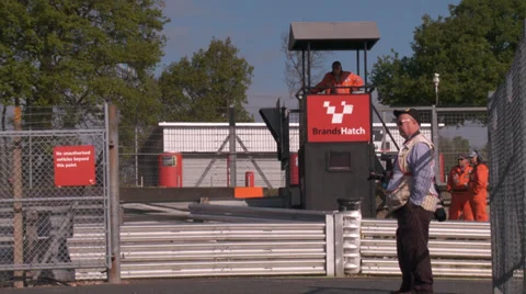 Pit lane pre race / time trials photographer and officials waiting around Stock Footage 38062881
