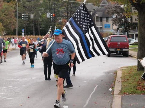 Pit Run runner carrying a Thin Blue Line Flag Stock Photos