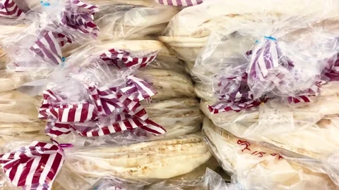 Pita arabic bread in a plastic bag piled up in a restaurant. Video stock 209169886