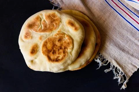 Pita bread on a dark table, top view Stock Photos