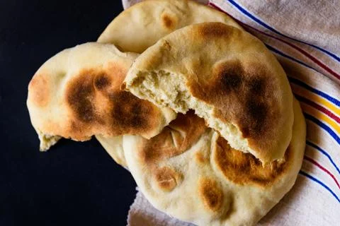 Pita bread on a dark table, top view Stock Photos