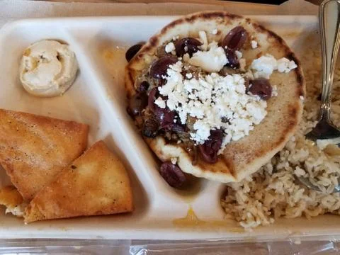 Pita bread with lamb and cheese and hummus on plate Stock Photos