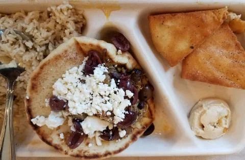 Pita bread with lamb and cheese and hummus on plate Stock Photos