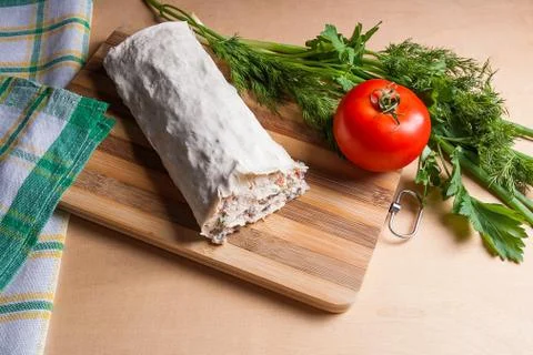 Pita bread or lavash wrapped with cottage cheese or curd, chicken, tomatoes a Foto stock