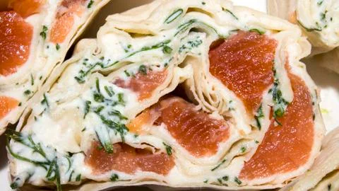Pita bread rolls with red fish.Background of the rolls with salmon in pita bread Stock Photos