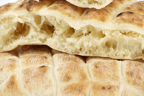 Pita flat-bread toasted of a grid pattern over white Pieces of pita flat-b... Stock Photos