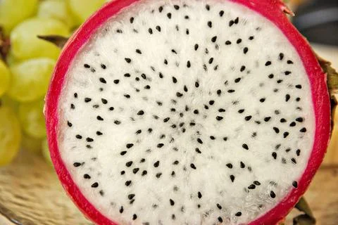 Pitaya dragon fruit in section white flesh with black seeds Stock Photos