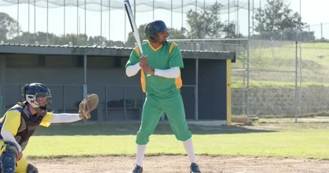 Pitch bouncing at home plate urging male batter picking ball adjusting grip Видео 336957207