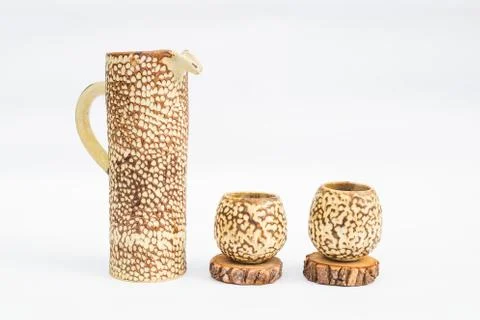 Pitcher and two ceramic stoneware glasses with white background Stock Photos