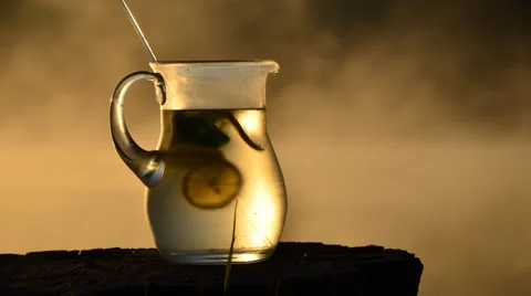 Pitcher with lemon and mint . It stirred in the jug lemon and mint ice . Stock Footage 63883530