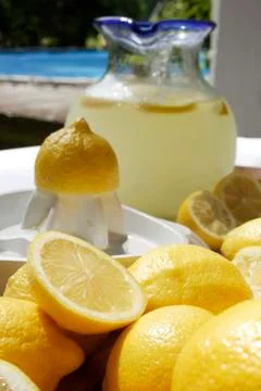 Pitcher of lemonade surrounded by lemons Stock Photos