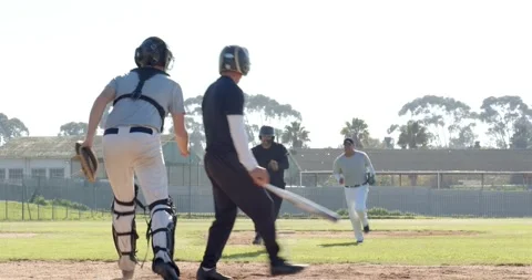 Pitcher pitching, batter swinging and missing, catcher chasing ball as runner Stock Footage 335682704
