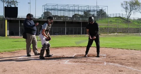 Pitcher pitching to plate, batter missing ball, catcher catching, umpire calling Stock Footage 341089034