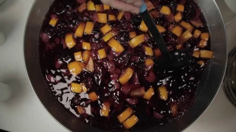 Pitcher with a red refreshing drink with lemon slices, orange and with berries Stock Footage 82648770