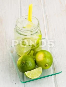 Pitcher refreshing drink with lime Stock Photos