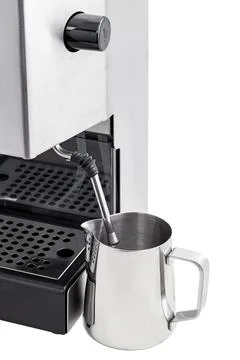 Pitcher with a steamer of a professional coffee machine. Stock Photos