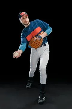 Pitcher warms up during practice on black background Stock Photos