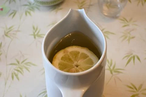 Pitcher of water with a lemon slice Stock Photos