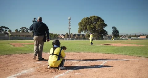 Pitcher winding up and releasing baseball, batter swinging racing to first base Stock Footage 336783847