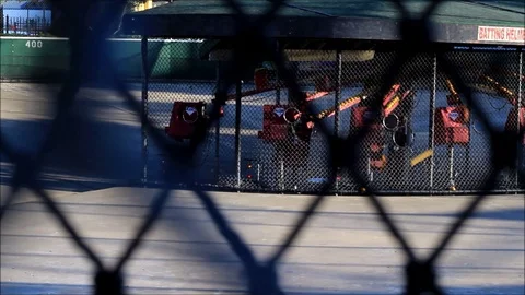 Pitching machine throwing baseballs at batter in batting cage 스톡 동영상 71415833