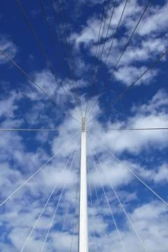 Pitching the ropes of a bridge with the sky in the background Stock Photos