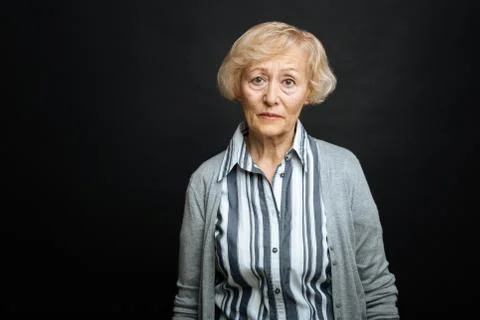 Pitiful aging woman demonstrating comparison indoors Stock Photos