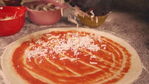 Pitsewalker sprinkles cheese on pizza Stock Footage 158403426