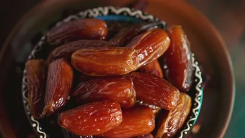 Pitted dates close up. Bowl with delicious dried dates. Ramazan iftar food Stock Footage 238561731