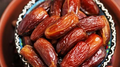 Pitted dates close up. Bowl with delicious dried dates. Ramazan iftar food Stock Footage 238561798