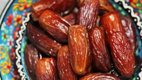 Pitted dates close up. Dried dates in bowl. Traditional iftar food. Boom shot Stock Footage 240562578