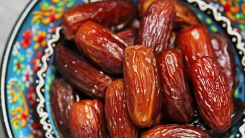 Pitted dates close up. Dried dates in bowl. Traditional iftar food. Boom shot Stock Footage 240562684