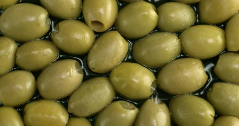 Pitted green olives background texture. Table spin. Stock Footage 282109594
