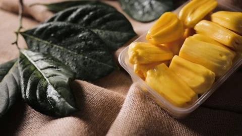 Pitted jackfruit meat and leaf on brown coffee bean burlap cloth, dolly move 動画素材 155471349