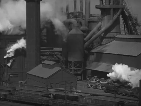 Pittsburgh, PA - 1940s: Train pulls into factory Stock Footage 232040561