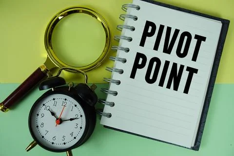 Pivot Point text written on notebook paper with magnifying glass and alarm .. Stock Photos