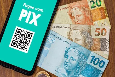 Pix on smartphone screen with multiple coins around. Pix is the new payment a Stock Photos