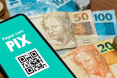 Pix on smartphone screen with multiple coins around. Pix is the new payment a Stock Photos