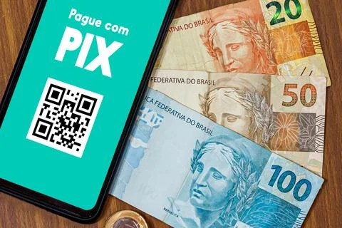 Pix on smartphone screen with multiple coins around. Pix is the new payment a Stock Photos
