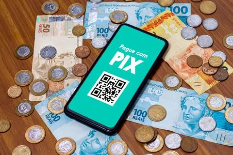 Pix on smartphone screen with multiple coins around. Pix is the new payment a Stock Photos