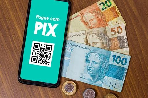 Pix on smartphone screen with multiple coins around. Pix is the new payment a Stock Photos
