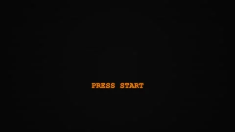 Pixel press start. Retro orange press start text on black scanline background Stock Footage 340549993