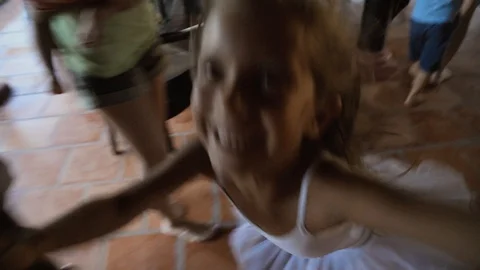 Pixie girl with shining eyes and happy smile jumping at party with adult people Stock Footage 96109069