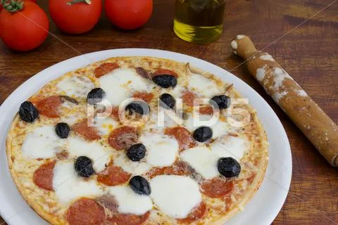 Pizza and olives Stock Photos