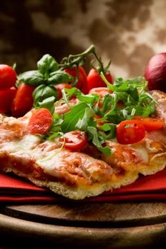 Pizza arugula and cherry tomatoes Stock Photos