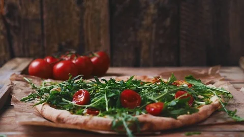 Pizza with arugula and tomatoes Video stock 75254532