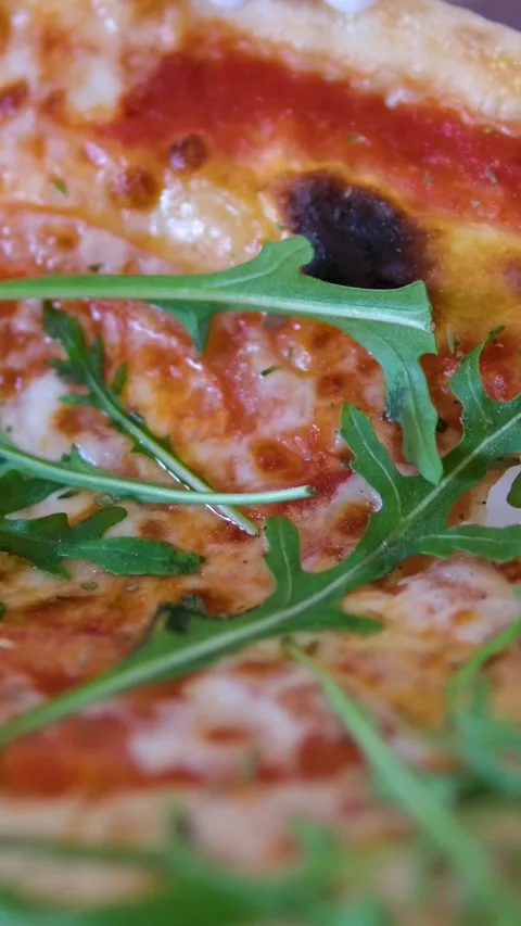 Pizza arugula hand Drizzling Extra Virgin Olive Oil on top of a Pizza Stock Footage 305984012